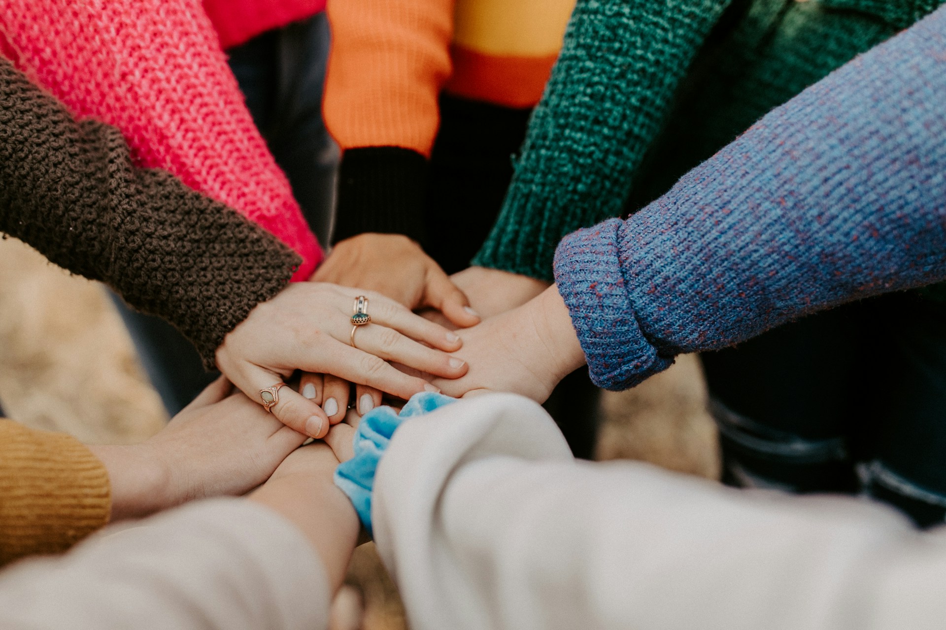 A group of people placing their hands on top of each other